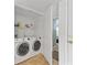 Convenient laundry room features a washer, dryer and storage shelf at 351 Lake Arrowhead Rd. # 131, Myrtle Beach, SC 29572