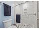 Close up of newly updated shower featuring grab bars, marble-look surround, and glass doors at 351 Lake Arrowhead Rd. # 131, Myrtle Beach, SC 29572