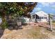 Inviting backyard featuring a white home, patio, outdoor grill, and a lush magnolia tree at 356 Boxcar Dr., Longs, SC 29568