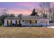 Charming single-story home with a welcoming front porch and an American flag at 356 Boxcar Dr., Longs, SC 29568