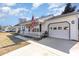 Exterior view of home featuring a white picket fence, front porch, and two car garage at 356 Boxcar Dr., Longs, SC 29568