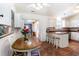 Bright kitchen featuring white cabinets, a dining table, and a breakfast bar at 356 Boxcar Dr., Longs, SC 29568