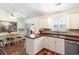 Kitchen featuring white cabinets, a dining table, breakfast bar, and stainless steel dishwasher at 356 Boxcar Dr., Longs, SC 29568