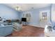 Bright living room with blue walls, comfortable seating, and decorative accents at 356 Boxcar Dr., Longs, SC 29568