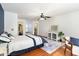This main bedroom features a ceiling fan, wood floors, and an ensuite bathroom with walk-in closet at 356 Boxcar Dr., Longs, SC 29568