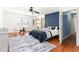 This main bedroom features a ceiling fan, wood floors, a decorative rug, and an ensuite bathroom at 356 Boxcar Dr., Longs, SC 29568