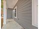 Side porch with gray siding, and an outdoor light fixture at 3837 Mayfield Dr., Conway, SC 29526