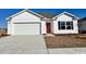 Charming single-Gathering home with a two-car garage, a red door, and bright white siding at 3866 Lady Bug Dr., Shallotte, NC 28470