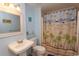 Light and airy bathroom featuring blue paint and shower with themed curtain at 4115 Little River Rd. # 4-F, Myrtle Beach, SC 29577