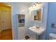 Well-lit bathroom with stylish fixtures and pedestal sink at 4115 Little River Rd. # 4-F, Myrtle Beach, SC 29577