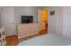 Bedroom featuring television, dresser, and an entryway to the stairs at 4115 Little River Rd. # 4-F, Myrtle Beach, SC 29577