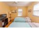 Bedroom featuring yellow walls, twin beds, natural light, and television at 4115 Little River Rd. # 4-F, Myrtle Beach, SC 29577