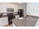 Well-equipped kitchen with granite countertops and updated appliances, providing a functional and stylish cooking space at 4115 Little River Rd. # 4-F, Myrtle Beach, SC 29577
