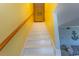 Bright yellow staircase leading to the upper level of the home at 4115 Little River Rd. # 4-F, Myrtle Beach, SC 29577