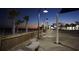 Scenic evening boardwalk view featuring palm trees, benches, and beachfront shops under the warm glow of streetlights at 423 Lifestyle Court, Surfside Beach, SC 29575