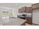 A modern kitchen with stainless steel appliances, granite counters, and island sink at 423 Lifestyle Court, Surfside Beach, SC 29575