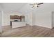 Spacious living area featuring wood floors, a ceiling fan and an open kitchen at 423 Lifestyle Court, Surfside Beach, SC 29575