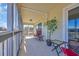 Relaxing screened balcony features outdoor seating and an area rug at 4350 Intercoastal Dr. # 2301, Little River, SC 29566