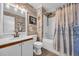 Coastal themed bathroom featuring wood accent walls and a tub-shower combo at 4350 Intercoastal Dr. # 2301, Little River, SC 29566