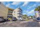 Exterior shot of a condominium building with multiple floors, balconies, and a parking lot with cars at 4350 Intercoastal Dr. # 2301, Little River, SC 29566