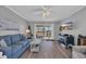 Comfortable living room with hardwood floors, a ceiling fan, and access to a balcony with ocean views at 4350 Intercoastal Dr. # 2301, Little River, SC 29566