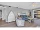 Well-lit living room with comfortable seating, stylish decor, and access to a balcony at 4350 Intercoastal Dr. # 2301, Little River, SC 29566