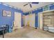 Bedroom with blue walls, Colts themed decor, ceiling fan, carpeted floor and walk in closet at 5040 Hampton Rd., Conway, SC 29527