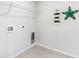 Functional laundry room with tile floor and a shelf for storage solutions at 543 Firouz Dr, Longs, SC 29568