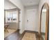 Bright entryway with light gray walls, wood-look floors, a wooden mirror, and a view into the adjacent living area at 6007 Forest Dell Ct, Myrtle Beach, SC 29579