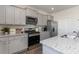 Modern kitchen boasts gray cabinets, stainless steel appliances, and granite countertops for a stylish design at 6007 Forest Dell Ct, Myrtle Beach, SC 29579
