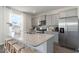 Modern kitchen with granite countertops, stainless steel appliances, a large island, and ample cabinet space at 6007 Forest Dell Ct, Myrtle Beach, SC 29579