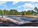 Outdoor volleyball court with well-maintained sand and blue netting at 6007 Forest Dell Ct, Myrtle Beach, SC 29579