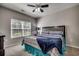 Comfortable bedroom with a large window, ceiling fan, and a colorfully decorated bed at 6253 Catalina Dr. # 1711, North Myrtle Beach, SC 29582
