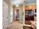 Hallway with a view into bedroom, kitchen with black refrigerator, and white doors at 6253 Catalina Dr. # 1711, North Myrtle Beach, SC 29582