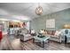 Open living room showcasing hardwood floors, a kitchen view, and neutral-toned furniture at 6253 Catalina Dr. # 1711, North Myrtle Beach, SC 29582