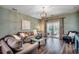 Living room with hardwood floors, neutral furniture, and sliding glass doors to patio at 6253 Catalina Dr. # 1711, North Myrtle Beach, SC 29582