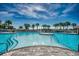 Large outdoor pool with multiple access points, palm trees, lounge chairs and seating areas at 6253 Catalina Dr. # 1711, North Myrtle Beach, SC 29582