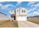 Charming two-story home showcasing neutral siding, a two-car garage, and a well-maintained front yard at 723 Joywood Dr., Longs, SC 29568