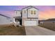 Two-story home featuring white siding, an attached two-car garage, and a well-maintained front lawn at 723 Joywood Dr., Longs, SC 29568