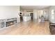 Open-concept living room with hardwood floors, a fireplace, and access to the kitchen and dining area at 723 Joywood Dr., Longs, SC 29568