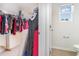Walk-in closet offering ample storage space for clothing and accessories with access to a partial bathroom at 723 Joywood Dr., Longs, SC 29568