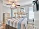 This cozy bedroom features a striped bedspread, dresser and beach themed decor at 7401 N Ocean Blvd. # 5, Myrtle Beach, SC 29572