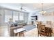 Bright living room featuring a neutral palette, large windows, ceiling fan, and dining area adjacent at 7401 N Ocean Blvd. # 5, Myrtle Beach, SC 29572