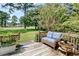 Wooden back deck with wicker furniture and view of the mature tree line at 75 Haig Ct., Georgetown, SC 29440