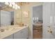 Bathroom with blue vanity, decorated wallpaper, and access to an adjacent bedroom at 75 Haig Ct., Georgetown, SC 29440