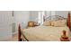 Comfortable bedroom featuring a wooden bedframe and serene natural light from the shuttered windows at 75 Haig Ct., Georgetown, SC 29440