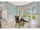 Cozy dining area with a round table and chairs, complemented by natural light from surrounding windows at 75 Haig Ct., Georgetown, SC 29440