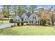 Charming single-story home featuring a manicured lawn, mature trees, and elegant architectural details at 75 Haig Ct., Georgetown, SC 29440