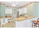 This kitchen features white cabinets and an island with room for seating at 75 Haig Ct., Georgetown, SC 29440