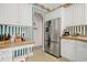 Bright kitchen with stainless steel refrigerator and white cabinets for ample storage space at 75 Haig Ct., Georgetown, SC 29440